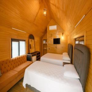 a bedroom with two beds and a couch at White Country Villages Hotel in Antalya
