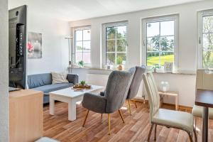 a living room with a couch and a table at Ferienapartment Sunshine in Zwinge