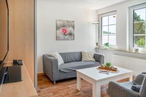 a living room with a couch and a table at Ferienapartment Sunshine in Zwinge