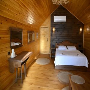 a bedroom with a bed and a wooden wall at White Country Villages Hotel in Antalya +92 photos