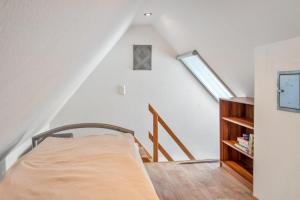 a bedroom with a bed and a stair case at Ferienapartment Sunshine in Zwinge