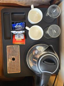 a close up of a food processor with plates and dishes at HKS Orchards Stay in Kanatal