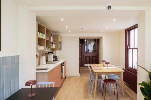 a kitchen with a table and chairs in a room at Merchant's House in Derry Londonderry