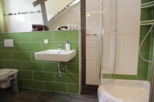 a bathroom with a sink and a shower at Branntweineralm in Tamsweg