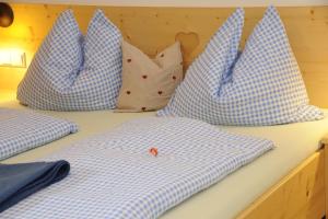four blue and white pillows sitting on a bed at Branntweineralm in Tamsweg
