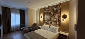 a hotel room with a bed and a painting on the wall at The Green Park Bostancı in Istanbul +37 photos