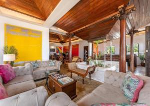 a living room with couches and a table at Villa Naina, Marari beach in Alleppey