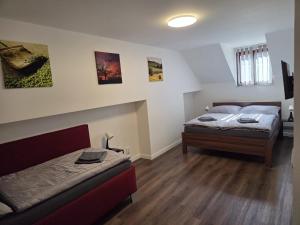 a bedroom with two beds in a room at Penzion u Nás u Hospůdky in Žatec