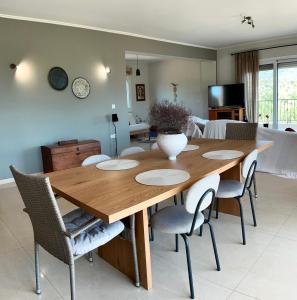 a dining room with a wooden table and chairs at Horizon House, with Olive Grove and a small Vineyard in Amarynthos