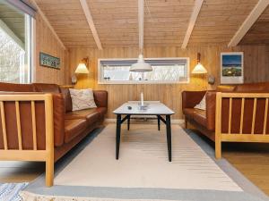 a living room with a couch and a table at 4 star holiday home in Jerup in Jerup