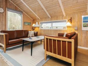 a living room with a couch and a table at 4 star holiday home in Jerup in Jerup