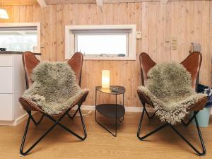 a room with two chairs and a table with a window at 4 star holiday home in Jerup in Jerup
