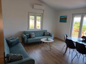 a living room with a couch and a table at Adria in Pašman