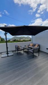 a black umbrella on the roof of a house at Mar & Monte in Angra do Heroísmo