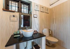 a bathroom with a sink and a toilet at Villa Naina, Marari beach in Alleppey +20 photos