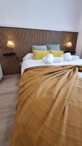 a large bed with a blanket on it in a room at Mar & Monte in Angra do Heroísmo