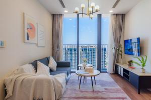 a living room with a couch and a table at Eco Green Apartment Residence District 7 in Ho Chi Minh City