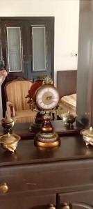 a table with a clock on top of a dresser at Penthouse Sea Apartment in El Mîna