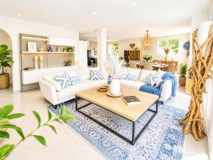 a living room with a couch and a table at Villa Del Sol with Mountain Views in Vence +27 photos