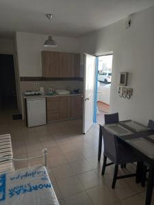 a kitchen and dining room with a table and a dining room at Apartment PAPAS in Mastihari