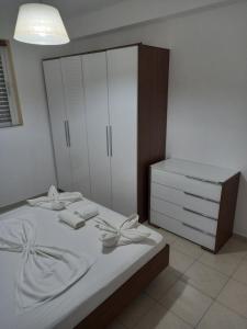 a bedroom with a white bed and a dresser at Apartment PAPAS in Mastihari