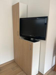 a flat screen tv sitting on top of a cabinet at L'échappée de Bras Long in Entre-Deux