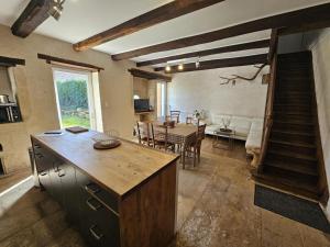 a kitchen and living room with a table and a dining room at Gite le rémijour in Céaux-en-Couhé