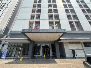 a man standing in front of a tall building at Collection O Expressia Stay in Tangerang