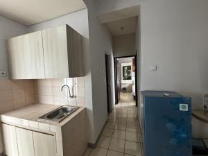a small kitchen with a sink and a hallway at Collection O Expressia Stay in Tangerang