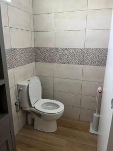 a bathroom with a white toilet in a room at L'échappée de Bras Long in Entre-Deux +10 photos