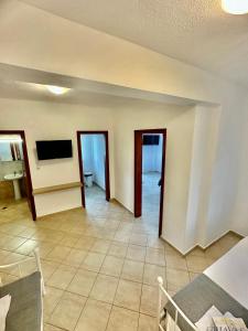 a living room with a tv on a wall at Griavas at campsite in Sykia Chalkidikis