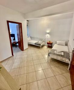 a bedroom with a bed and a room with a table at Griavas at campsite in Sykia Chalkidikis