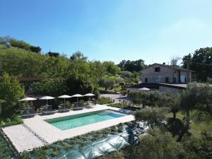 an overhead view of a swimming pool with umbrellas at Gastronomic Country House CarloCarla in Monte San Pietrangeli