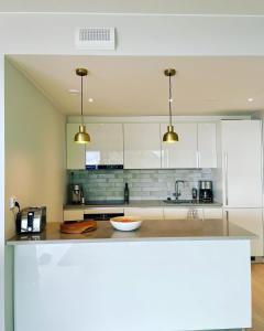 a kitchen with white cabinets and a counter top at A13 Premium Double room II floor in Hanko +13 photos