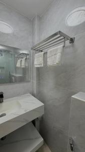 a white bathroom with a sink and a mirror at Ocean Bounty in Ukulhas +38 photos