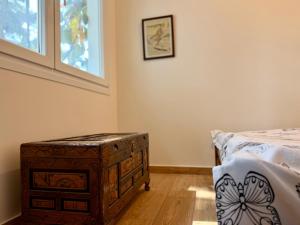 a bedroom with a wooden chest next to a bed at Themis in Aghia Marina