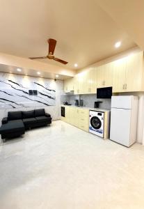 a living room with a couch and a kitchen at Ocean Bounty in Ukulhas