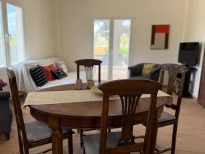 a room with a table and chairs and a living room at Themis in Aghia Marina