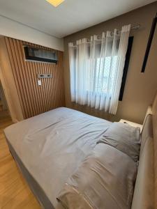 a large bed in a room with a window at Piscine Statio Resort Brás in São Paulo +11 photos