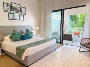 a bedroom with a large bed and a balcony at Ki Residences Apartments & Penthouse by LOV Mauritius, Pereybere in Pereybere +121 photos