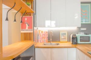 a kitchen with a sink and a microwave at Manzi 40 in Civitavecchia