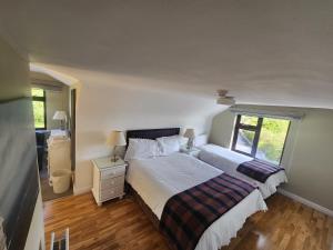 a bedroom with a large bed and a window at Ben Breen House Apartment in Crockaunroe