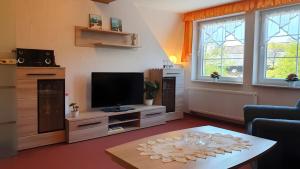 a living room with a television and a table at Ferienwohnung 2 in Bad Wilsnack