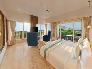 a bedroom with a bed and a view of the ocean at Tropical Retreat By Zuper in Igatpuri +23 photos