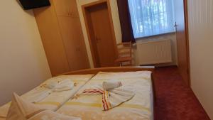 a bed with white sheets with bows on it at Ferienwohnung 1 in Bad Wilsnack