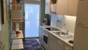 a kitchen with a sink and a stove top oven at Ferienwohnung 1 in Bad Wilsnack