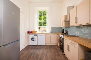 a kitchen with a washer and dryer at Garden Flat- Private Luxury in Ashkirk