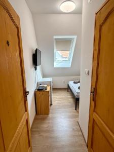 a hallway with a room with a bed and a window at Kékkúti Apartman in Kékkút