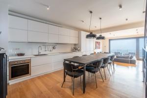 a kitchen and dining room with a table and chairs at Lake Como View 3BR Regina 35 in Carate Urio