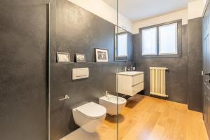 a bathroom with a toilet and a sink at Lake Como View 3BR Regina 35 in Carate Urio +58 photos